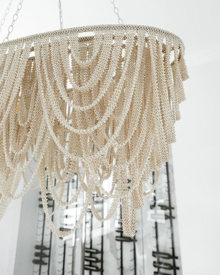 Tiny coco beads hand-sewn into draping ribbons, suspended