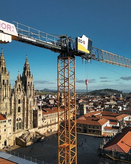 image by liebherrconstruction containing building, crane, church, tower, city
