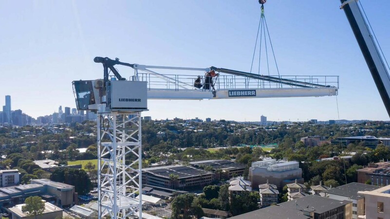 image by liebherrtowercranes containing crane, city, man, job, lift