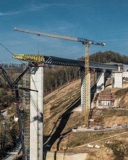 image by liebherrconstruction containing build, crane, bridge, construction site, hill
