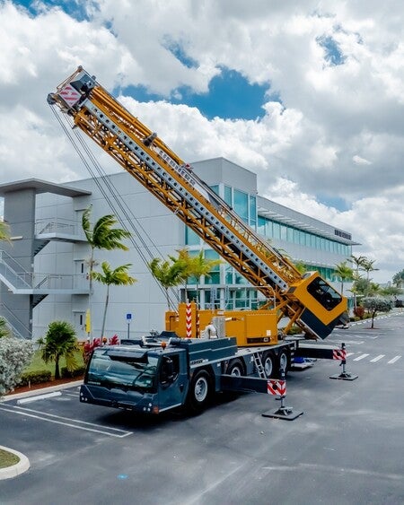 image by liebherrusa containing truck, crane, building, parking lot, blue