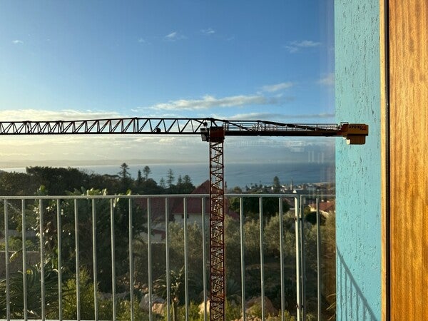 image by anonymous containing balcony, crane, window, sea, building