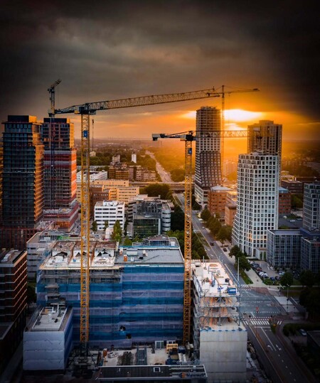 image by anonymous containing building, city, crane, skyscraper, sunset