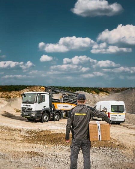 image by liebherrusa containing man, truck, stand, box, carry