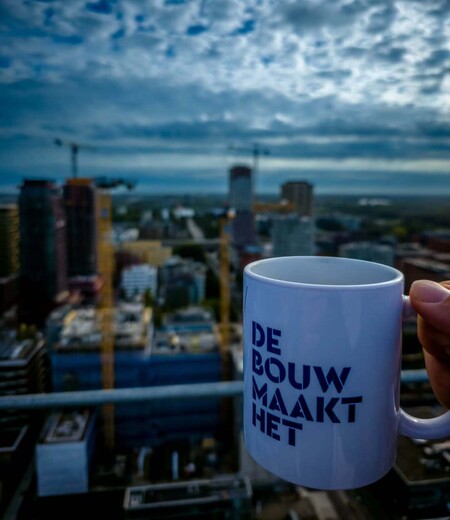 image by anonymous containing mug, coffee cup, catch, person, city