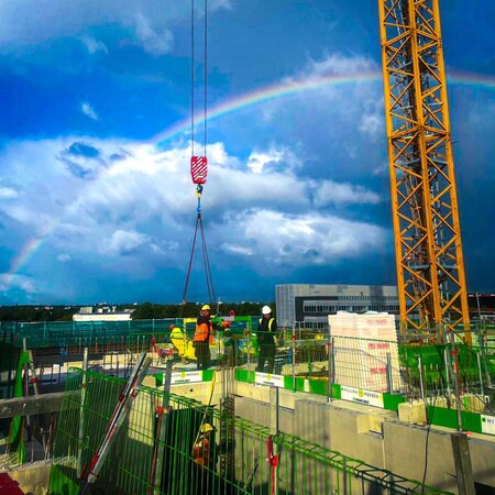 image by anonymous containing rainbow, crane, construction site, construction worker, sky