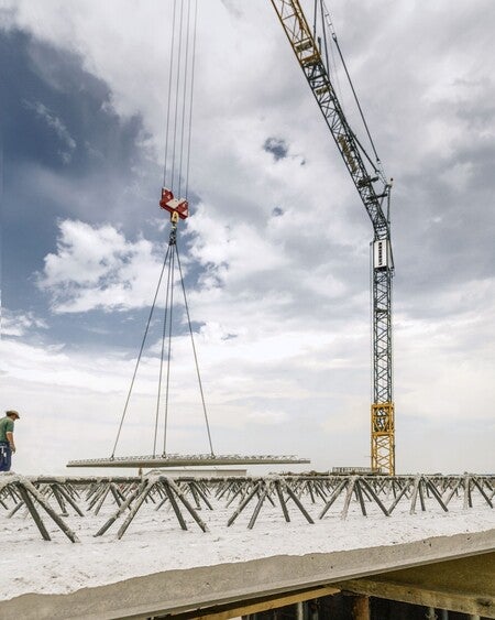 image by liebherrusa containing crane, man, person, stand, snow