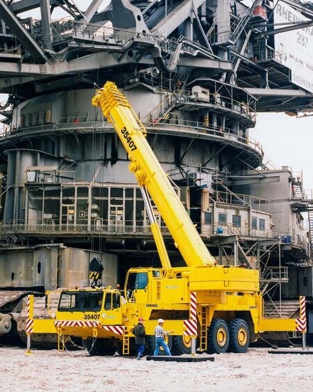 image by LiebherrConstruction containing crane, yellow, man, job, worker