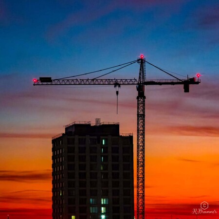 image by anonymous containing building, crane, sunset, sky, city