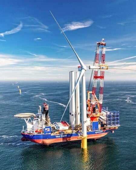 image by LiebherrConstruction containing wind turbine, sea, windmill, water, wind farm