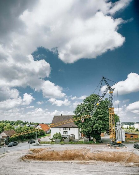 image by LiebherrConstruction containing crane, house, build, building, tree